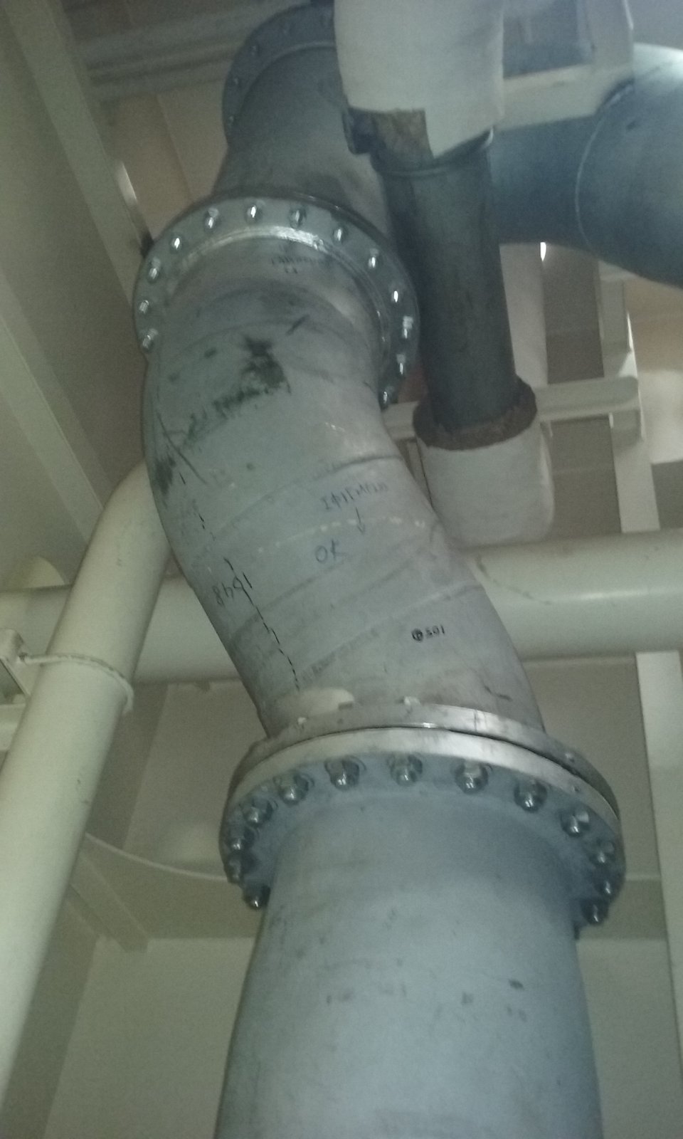 Large-diameter flanged piping section integrated into an existing vessel system.