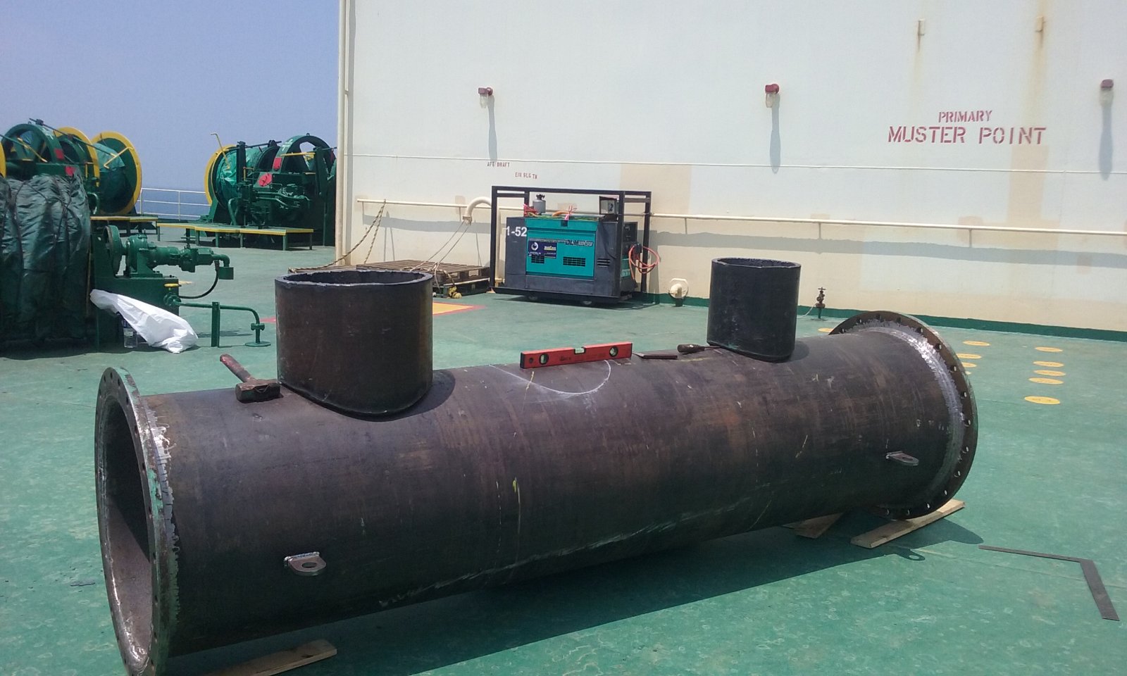 Custom large-diameter flanged pipe spool with branch connections positioned on a vessel deck.