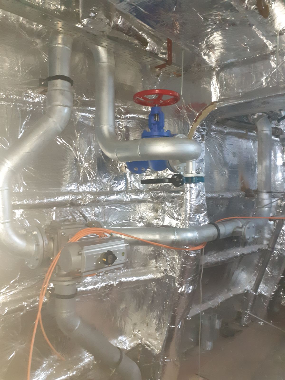 On-board piping fabrication and valve installation within an insulated vessel machinery space